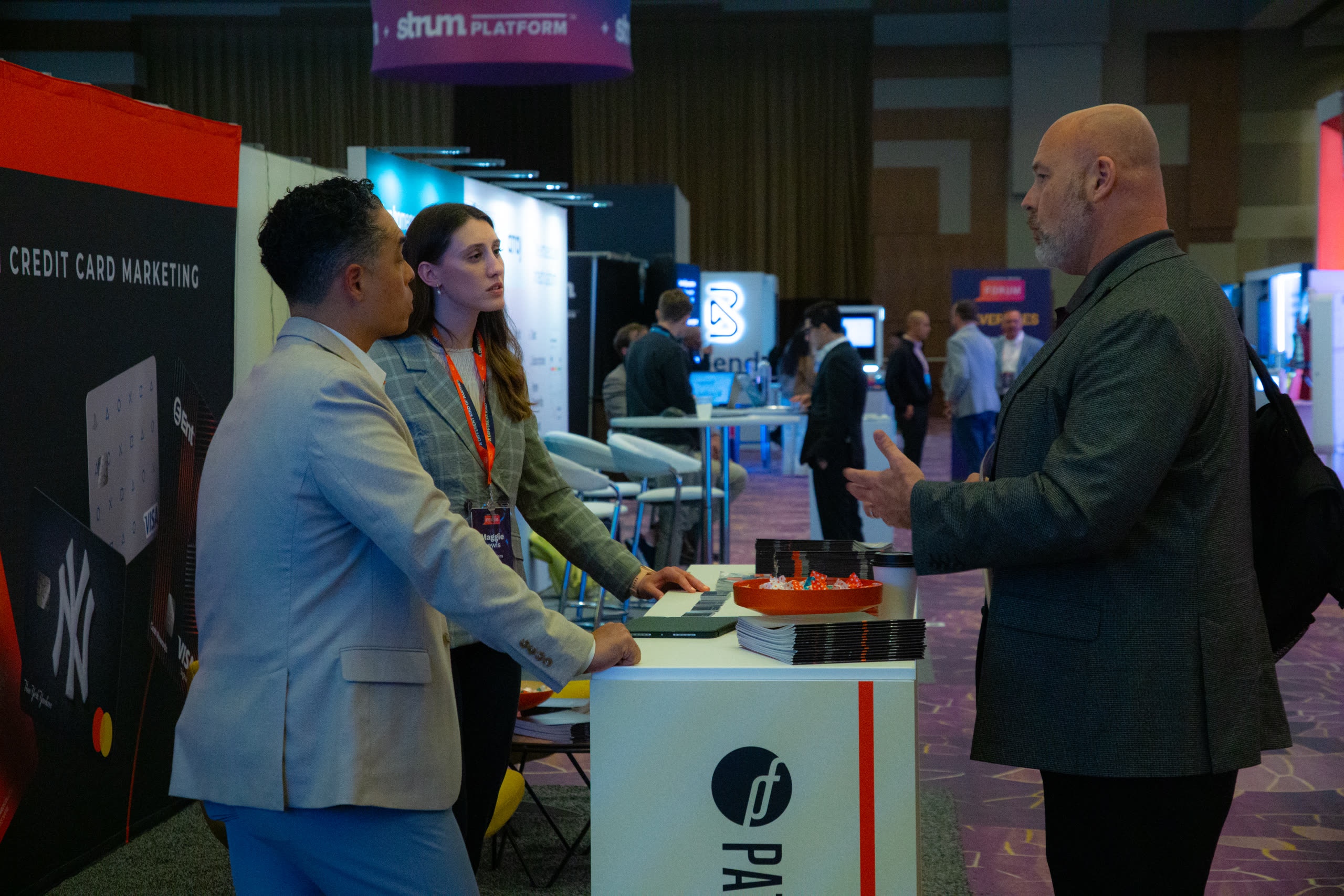 Forum attendees talking near the exhibit hall