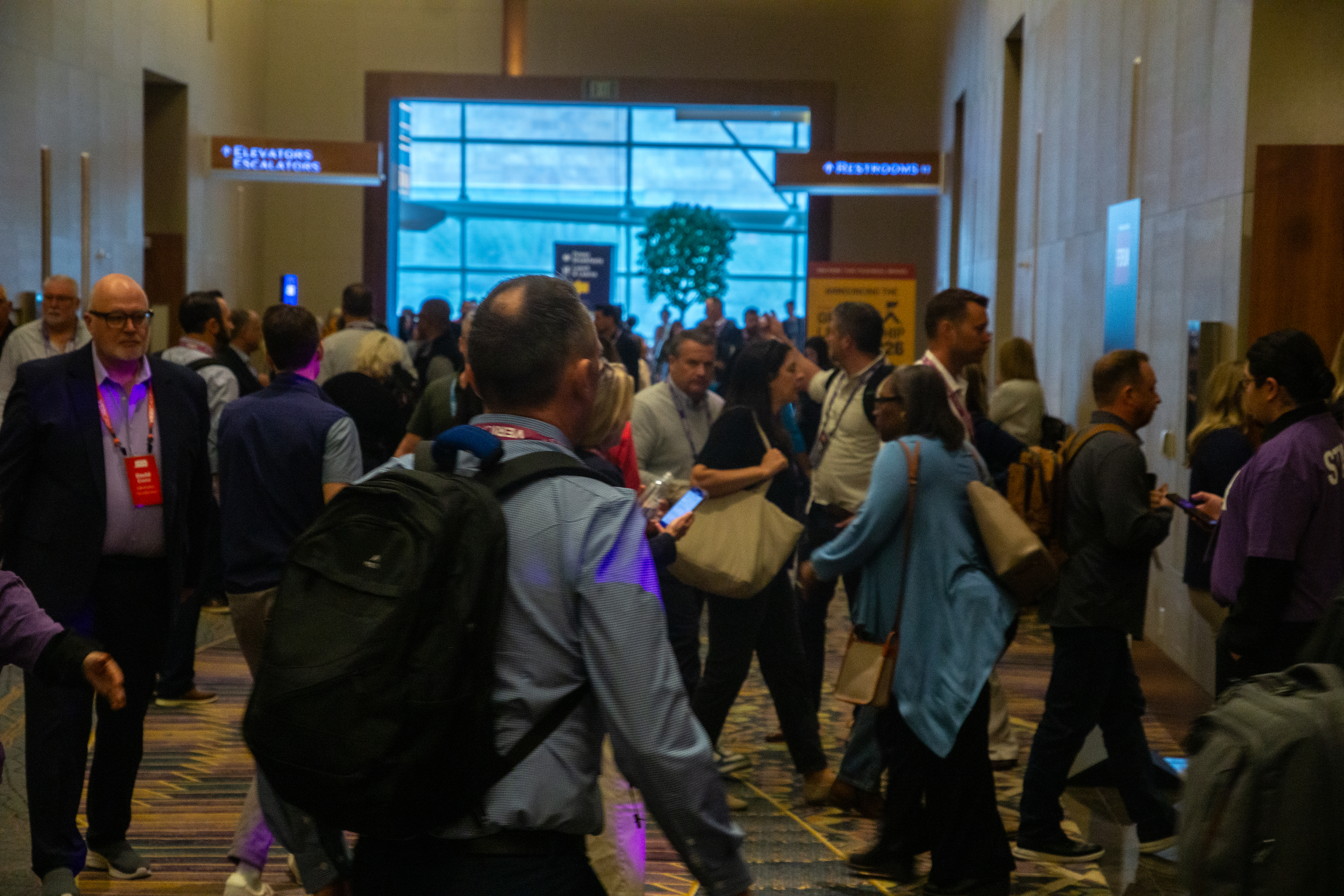 Attendees moving through the Forum venue